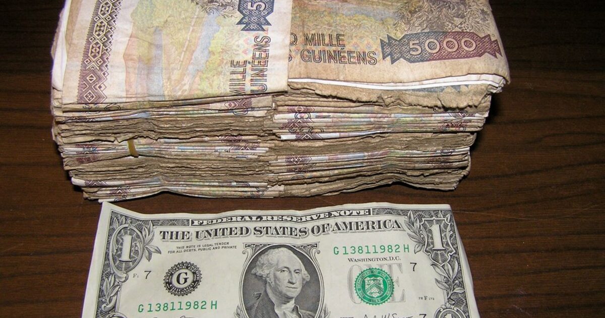 US dollar banknotes fanned out on a table